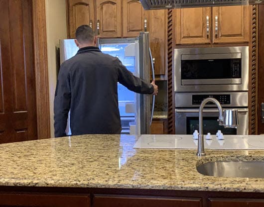 homewatcher inspecting refrigerator