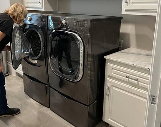 homewatcher inspecting the washing machine